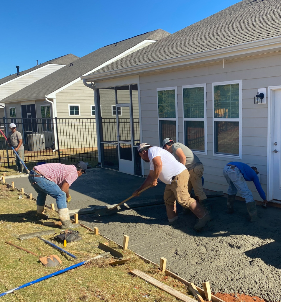 zeus concrete workers laying a cement patio